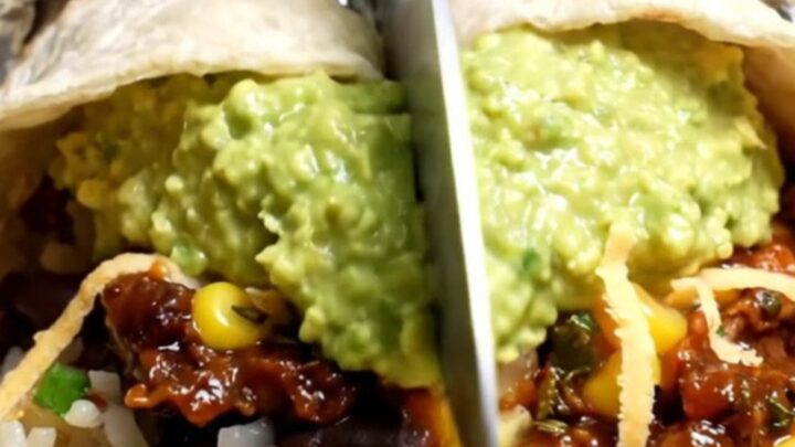 Foil-wrapped copycat barbacoa burrito sliced open, showing shredded chipotle beef, cilantro-lime rice