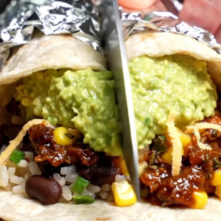 Foil-wrapped copycat barbacoa burrito sliced open, showing shredded chipotle beef, cilantro-lime rice