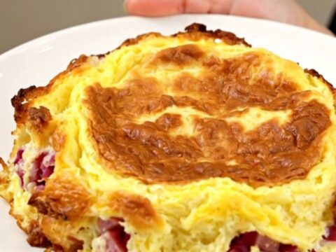 Golden slow cooker Denver omelet breakfast casserole with layers of hash browns, ham, peppers and melted cheddar