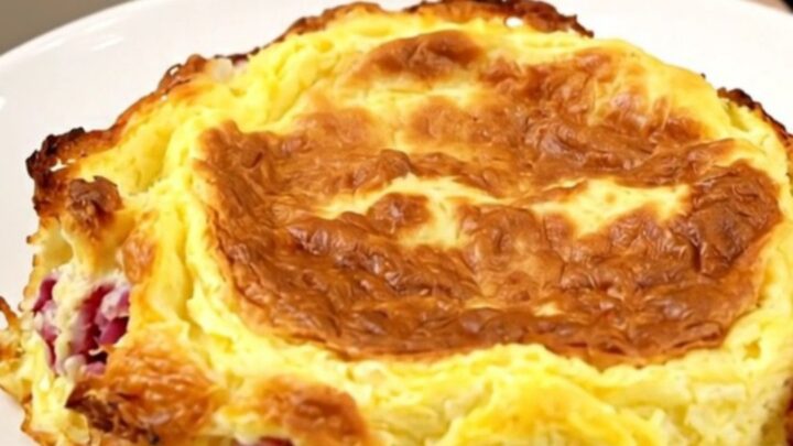Golden slow cooker Denver omelet breakfast casserole with layers of hash browns, ham, peppers and melted cheddar