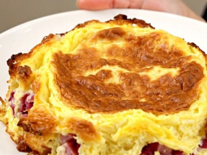 Golden slow cooker Denver omelet breakfast casserole with layers of hash browns, ham, peppers and melted cheddar