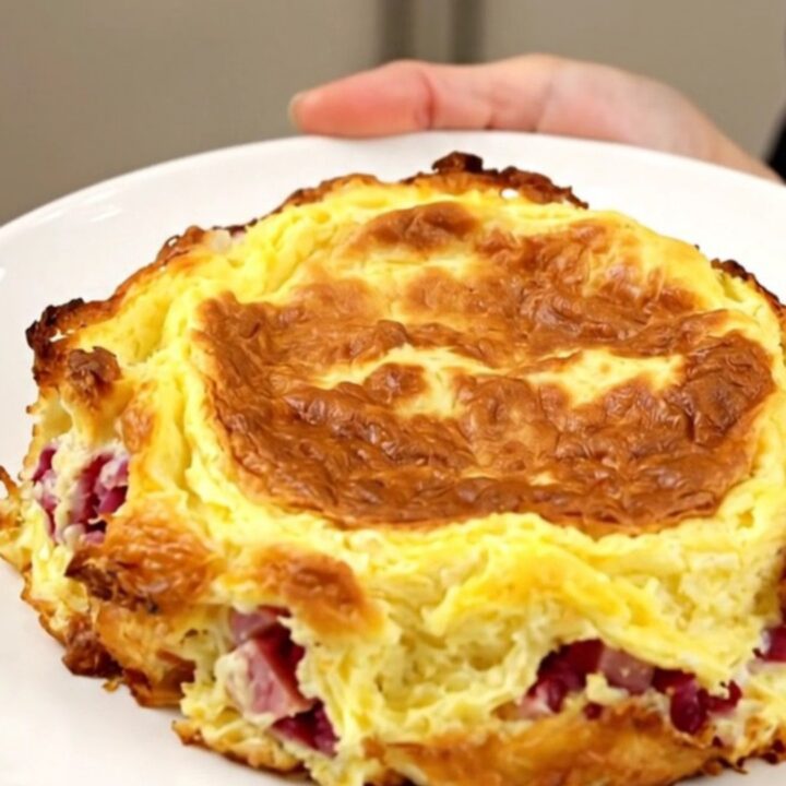 Golden slow cooker Denver omelet breakfast casserole with layers of hash browns, ham, peppers and melted cheddar