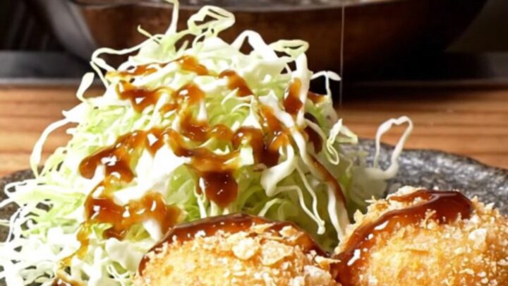 Golden fried wagyu potato korokke sliced in half, steam rising from the creamy filling