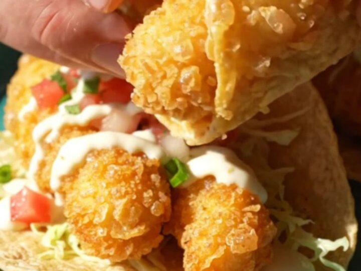 Beer-battered Baja fish tacos on corn tortillas with cabbage, pico de gallo, and white garlic-lime sauce
