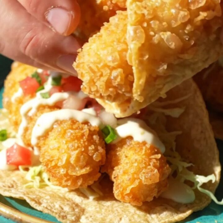 Beer-battered Baja fish tacos on corn tortillas with cabbage, pico de gallo, and white garlic-lime sauce