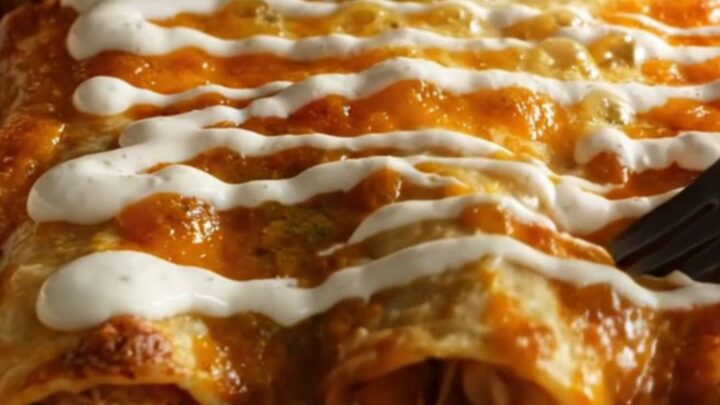 Baking dish of chicken enchiladas verdes in glossy green poblano sauce with melted Chihuahua cheese and charred corn