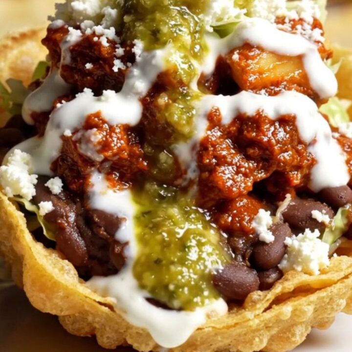 Crispy handmade sope with pinched golden rim overflowing with refried black beans, chicken tinga, lettuce