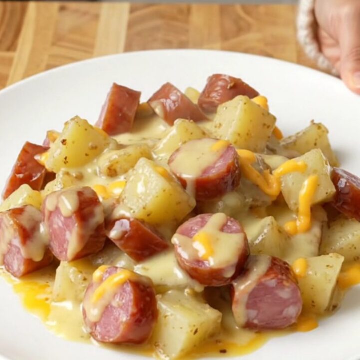 Crockpot cheddar garlic kielbasa and potatoes on a white plate