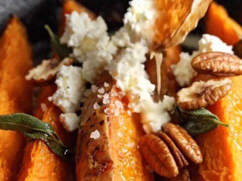 Crispy accordion sweet potato wedges in a cast-iron skillet, fanned ridges topped with brown butter, crispy sage