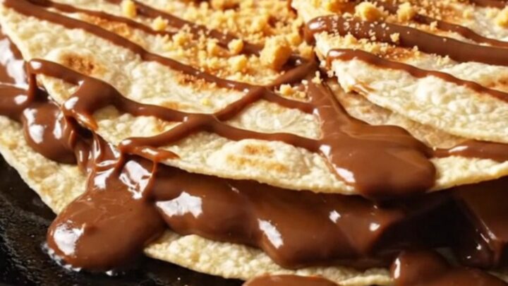 S'mores quesadilla wedges pulled apart, stretching strings of toasted marshmallow and melted milk chocolate with graham