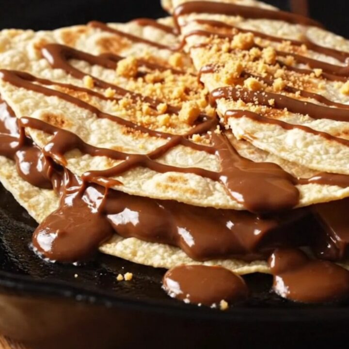 S'mores quesadilla wedges pulled apart, stretching strings of toasted marshmallow and melted milk chocolate with graham