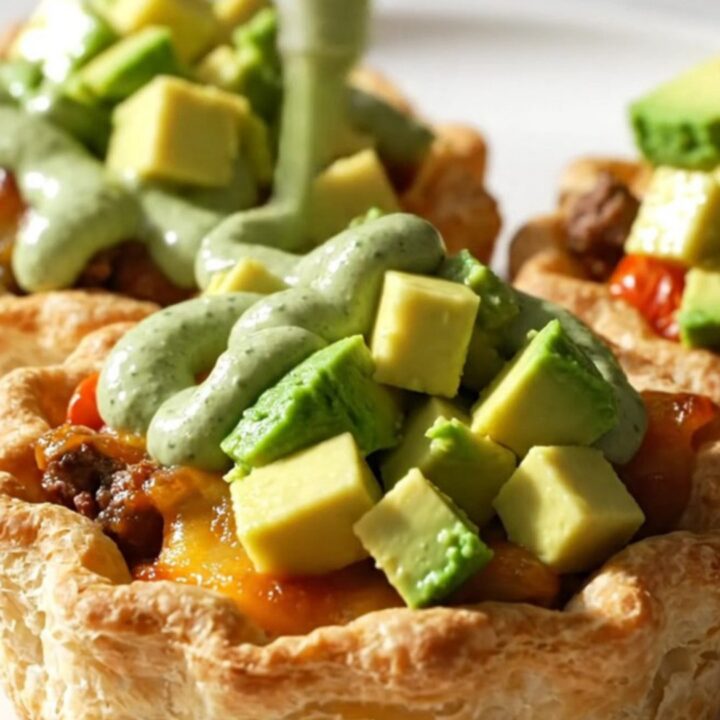 Upside-down taco tarts with golden cheddar crust, spiced beef, blistered cherry tomatoes, crema