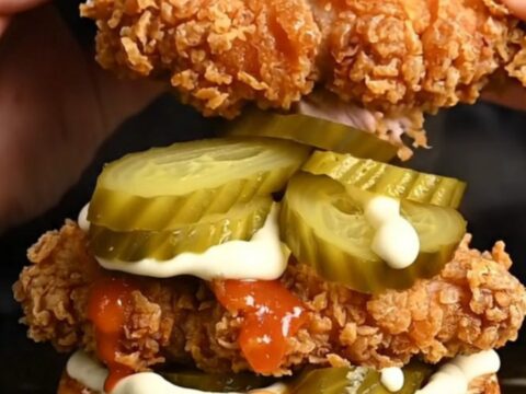 Crispy buttermilk fried chicken sandwich on a brioche bun with pickles and spicy mayo