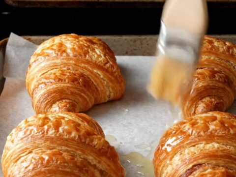 Two-tone chocolate croissant buns with zebra spiral layers on a baking sheet