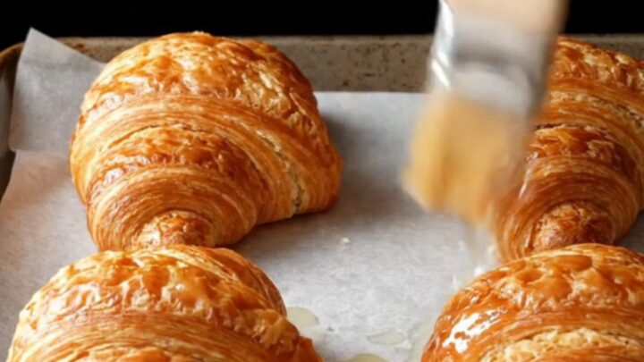 Two-tone chocolate croissant buns with zebra spiral layers on a baking sheet