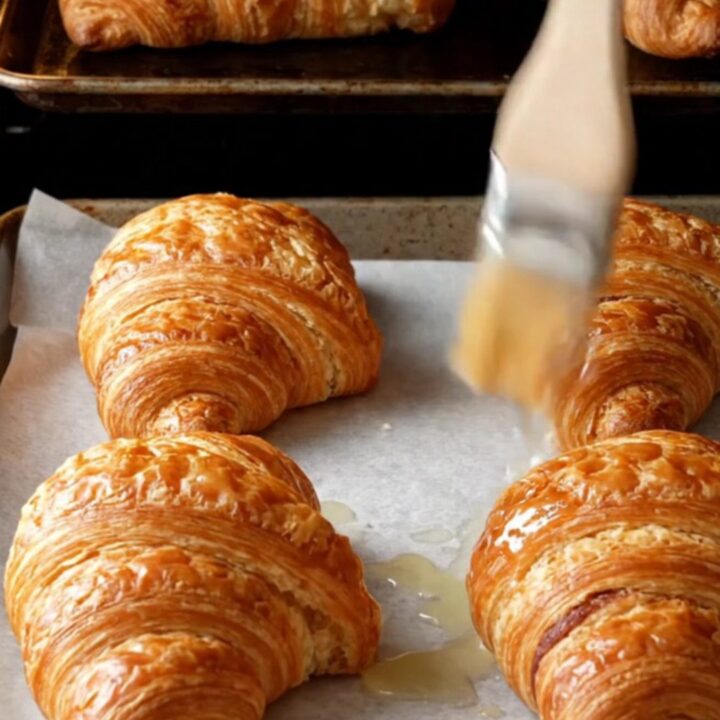 Two-tone chocolate croissant buns with zebra spiral layers on a baking sheet
