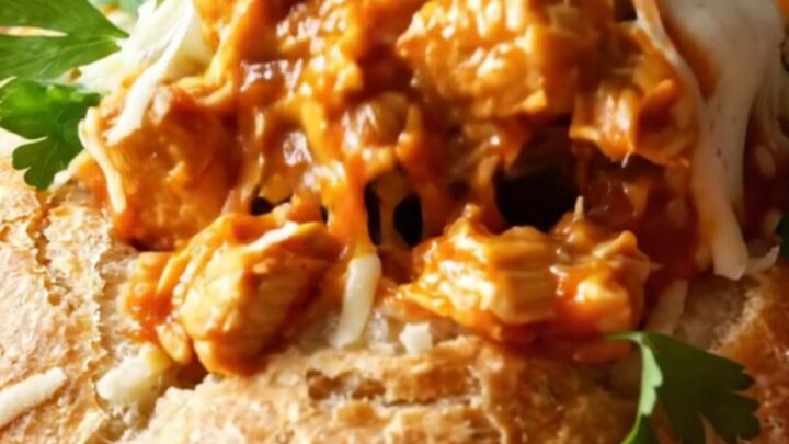 Golden bread pot casserole with melted mozzarella and a bread lid on top