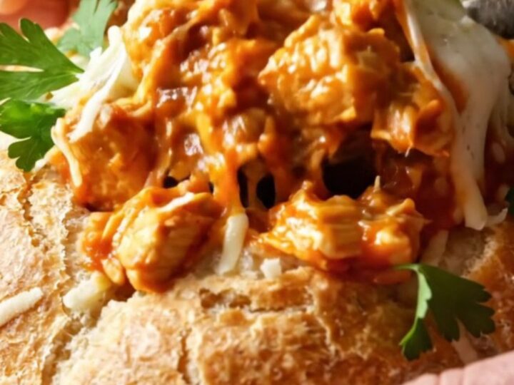 Golden bread pot casserole with melted mozzarella and a bread lid on top