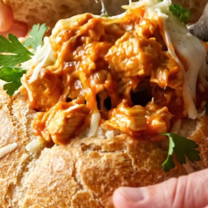 Golden bread pot casserole with melted mozzarella and a bread lid on top