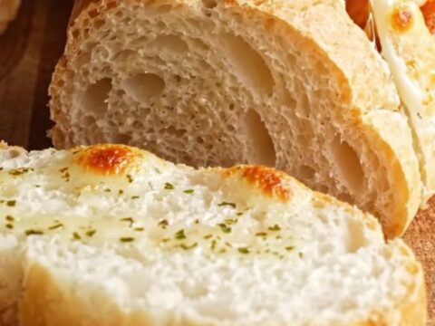Golden stuffed garlic bread with cheese pull and Cajun chicken