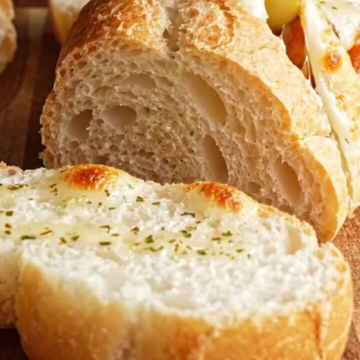 Golden stuffed garlic bread with cheese pull and Cajun chicken