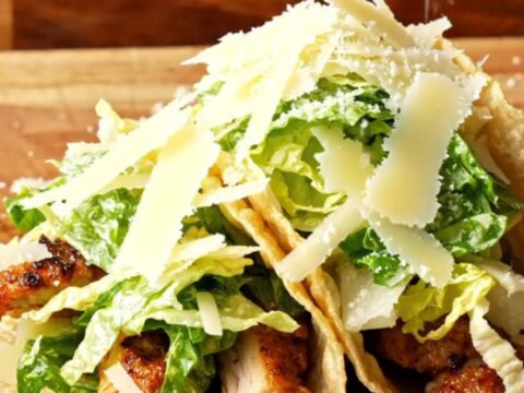 Crispy Chicken Caesar Smash Tacos piled with Caesar salad and shaved parmesan