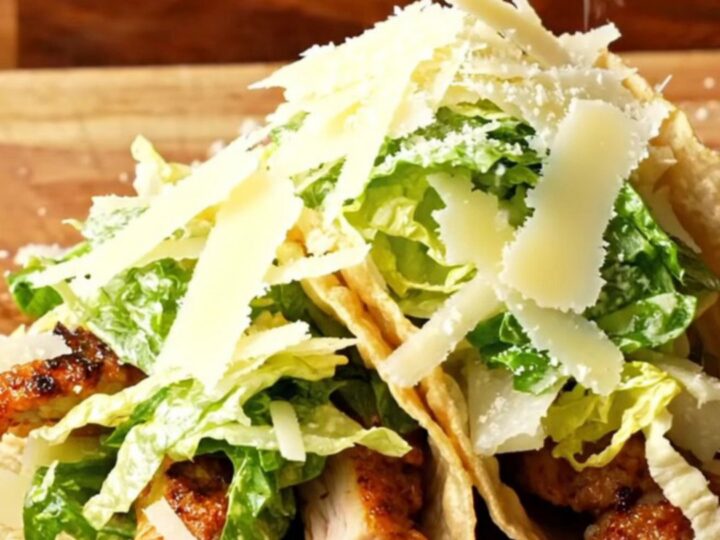 Crispy Chicken Caesar Smash Tacos piled with Caesar salad and shaved parmesan