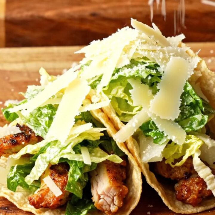 Crispy Chicken Caesar Smash Tacos piled with Caesar salad and shaved parmesan