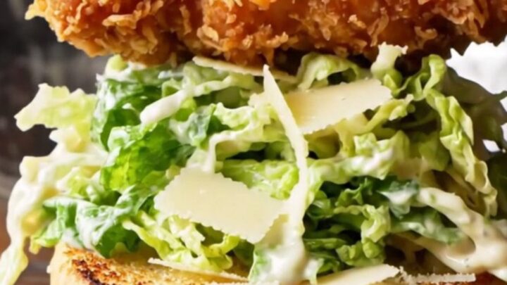 Crispy chicken Caesar sandwich on a toasted brioche bun with romaine and parmesan.
