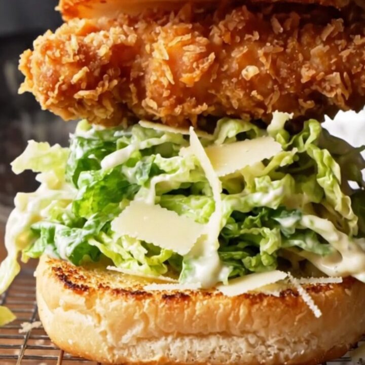 Crispy chicken Caesar sandwich on a toasted brioche bun with romaine and parmesan.