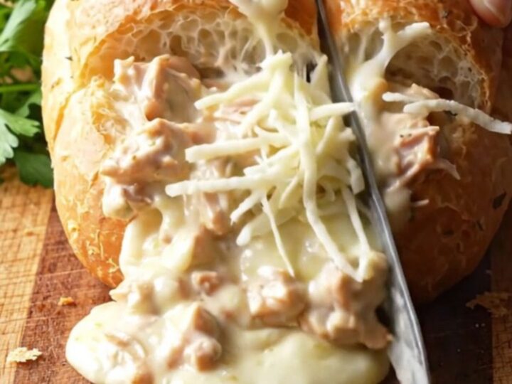 Cheesy Chicken Alfredo Stuffed Garlic Bread with melted mozzarella pull
