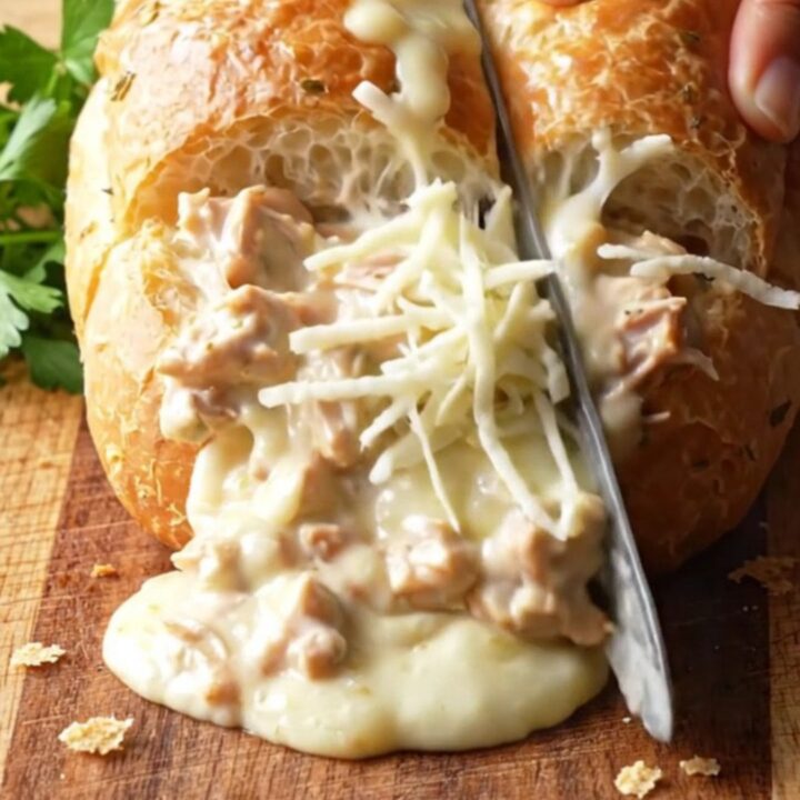 Cheesy Chicken Alfredo Stuffed Garlic Bread with melted mozzarella pull