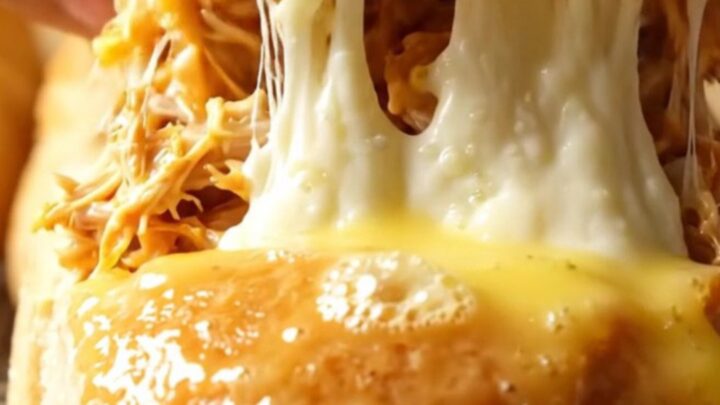 Golden pull-apart rolls with melted mozzarella stretching between them