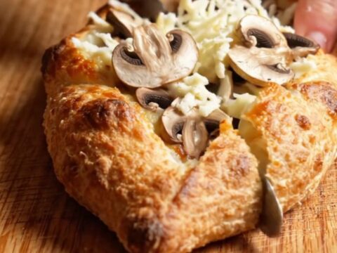 Mini garlic mushroom pide with golden crust and melted cheese pull