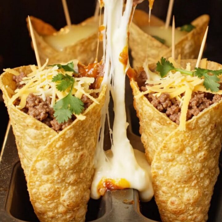 Crispy tortilla cone filled with ground beef and melted mozzarella, cheese pulling as it is lifted