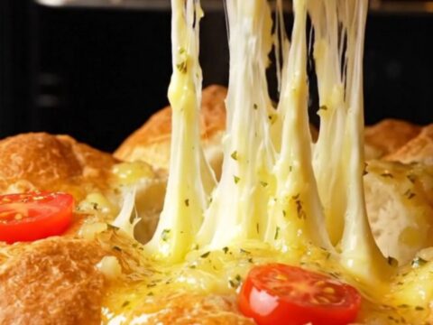 Pull-apart bread bites with golden crust and melted cheese stretching between them