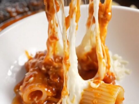 One-pan mini meatballs and shell pasta in a skillet with melted mozzarella