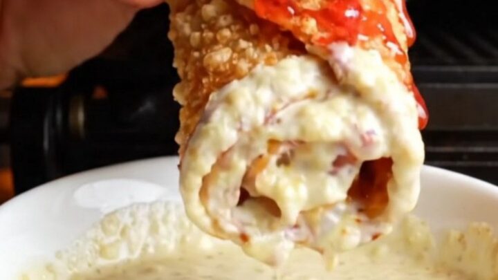 Crispy chicken shawarma wrap sliced diagonally showing chicken, fries, onions, and toum