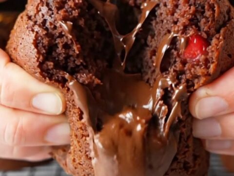 Double chocolate strawberry banana muffins with melted chocolate and berry pieces on a cooling rack