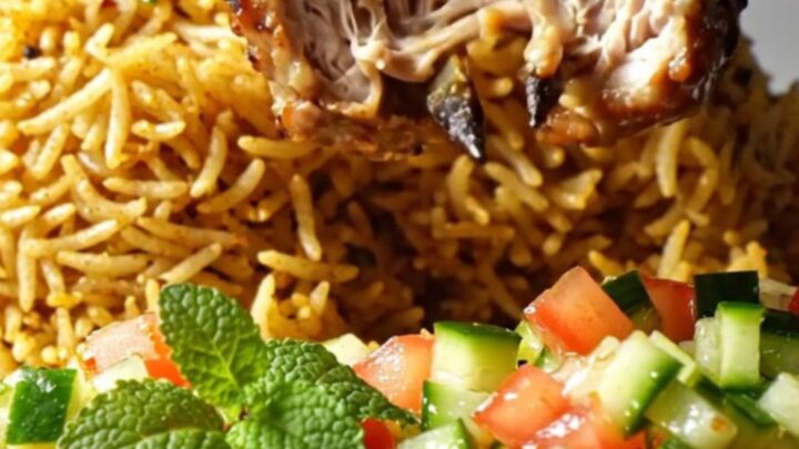Charred minced chicken kebabs on a skewer over saffron rice with cucumber-tomato salad