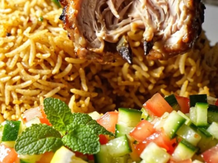 Charred minced chicken kebabs on a skewer over saffron rice with cucumber-tomato salad
