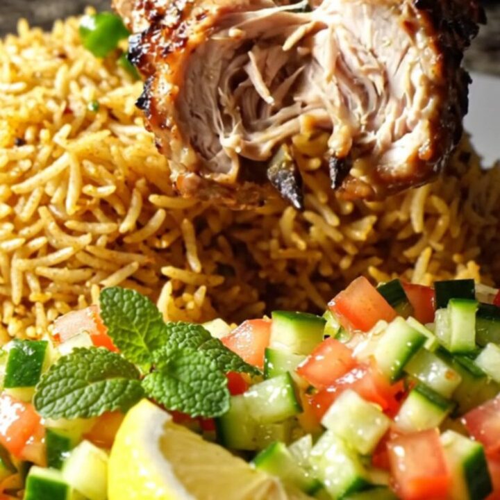 Charred minced chicken kebabs on a skewer over saffron rice with cucumber-tomato salad