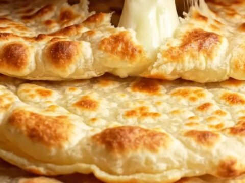 Turkish pan-toasted cheesy potato flatbreads stacked on a plate, golden and buttery