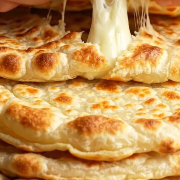 Turkish pan-toasted cheesy potato flatbreads stacked on a plate, golden and buttery