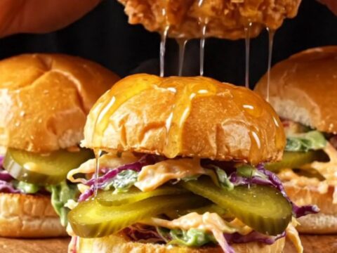 Hot honey buttermilk chicken sliders with glossy glaze, pickles, and slaw on toasted brioche