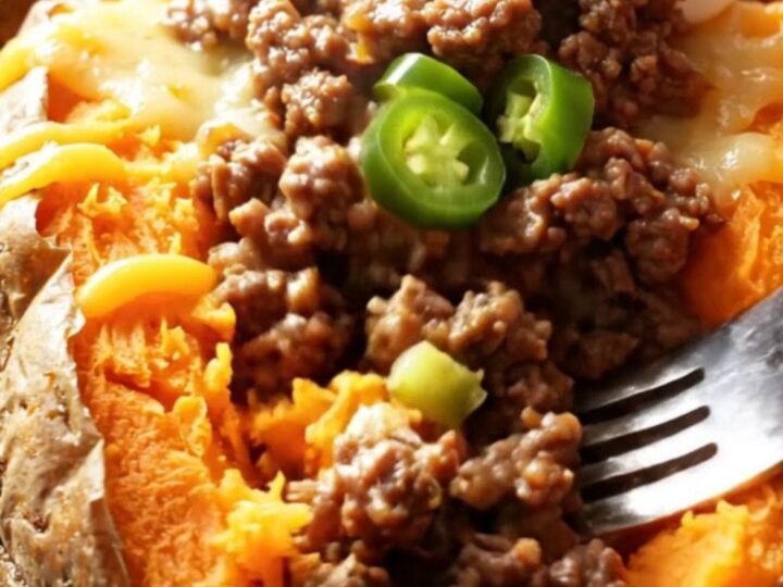 Loaded baked sweet potatoes with spiced beef, melted cheddar, cilantro, and sour cream