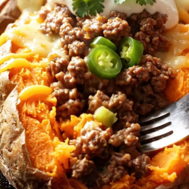 Loaded baked sweet potatoes with spiced beef, melted cheddar, cilantro, and sour cream