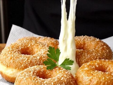 Golden crispy chicken and potato doughnuts with melted cheese pull