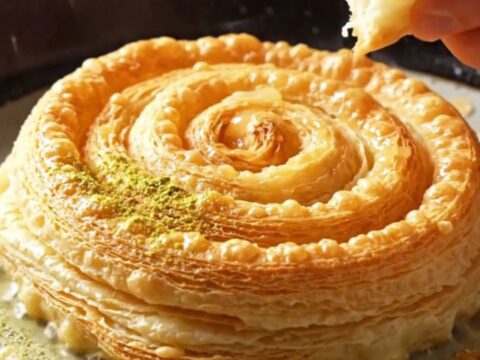 Warm Katmer with shattering crispy layers on a plate