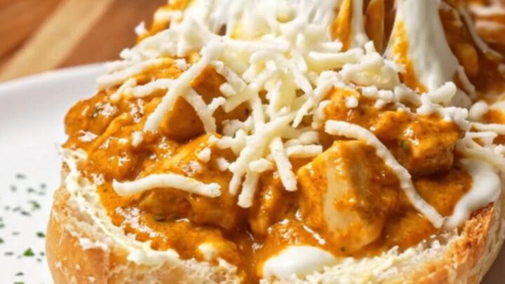 Loaded baguette with butter chicken and melted mozzarella, golden and bubbling
